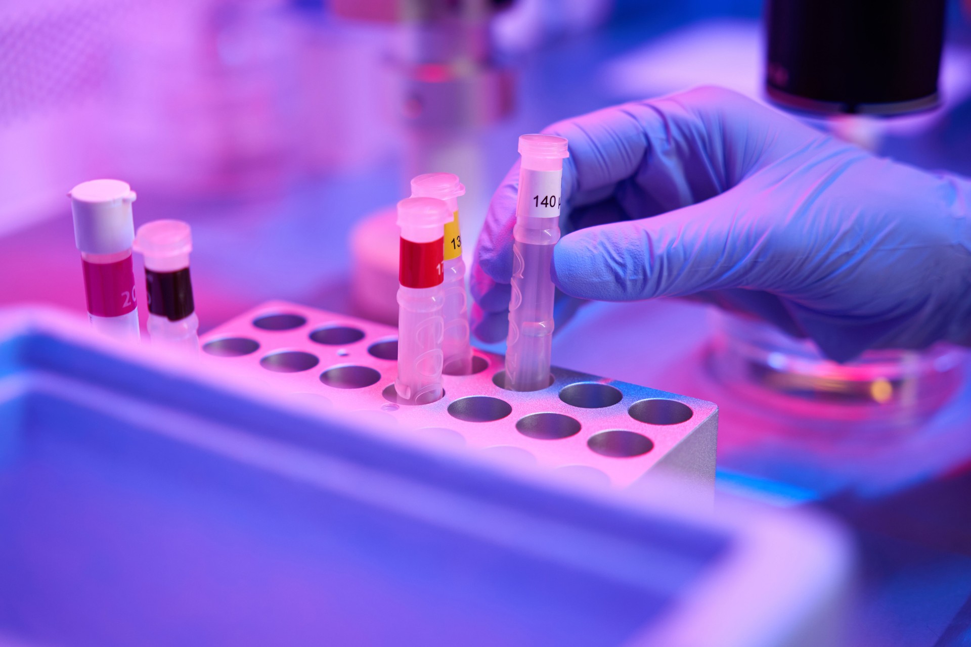 Person inserts a test tube into the cell